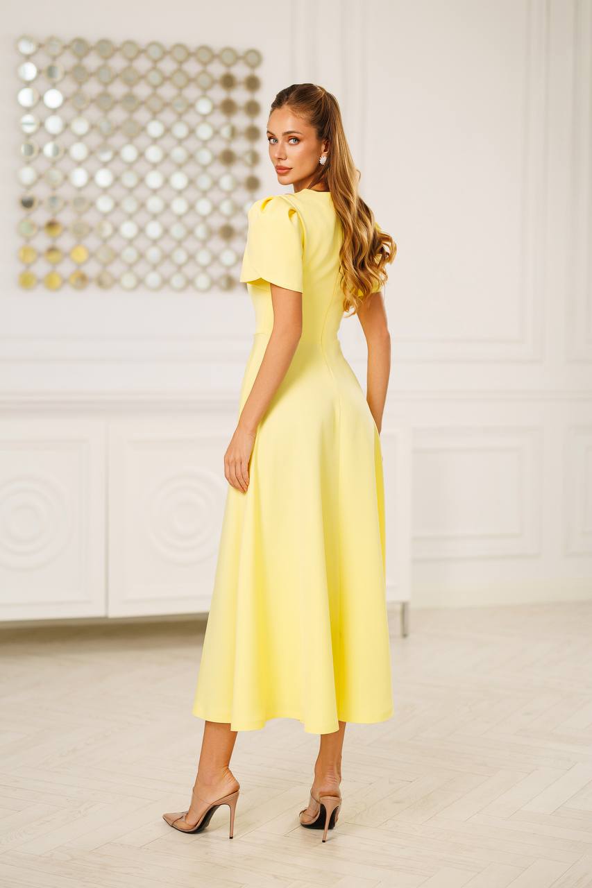 Woman wearing a yellow dress in an indoor setting