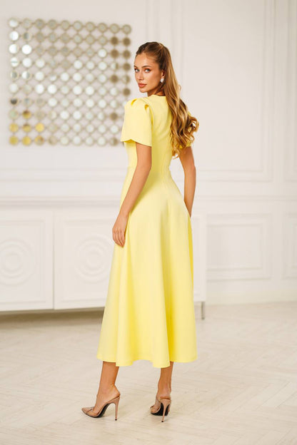 Woman wearing a yellow dress in an indoor setting