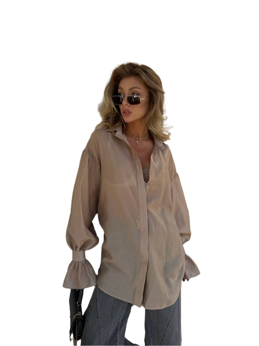 Woman wearing a beige blouse and sunglasses on a white background