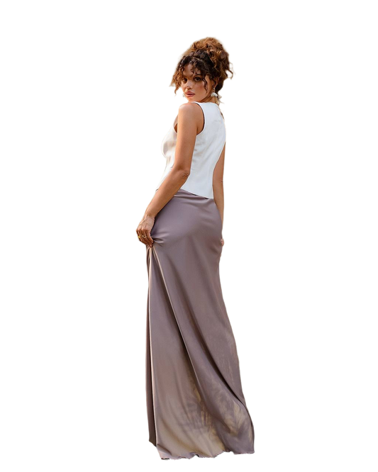 Woman wearing a white sleeveless top and long beige skirt on a white background