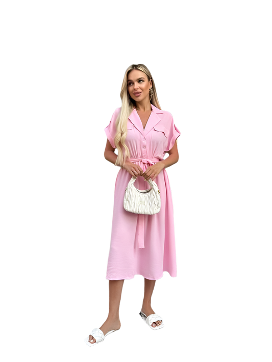 Woman wearing a pink dress holding a white handbag on a white background