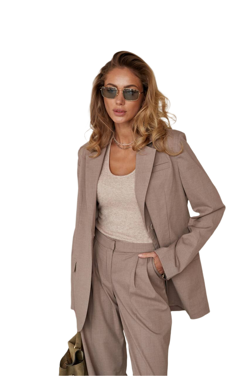 Woman wearing a beige suit and sunglasses on a white background