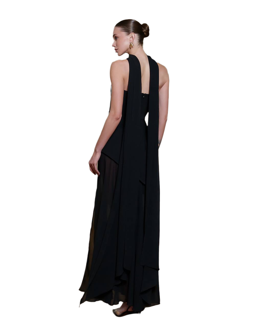 Black evening gown with a sheer overlay on a white background