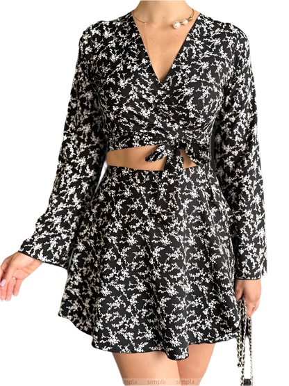 Black and white floral dress with long sleeves on a white background