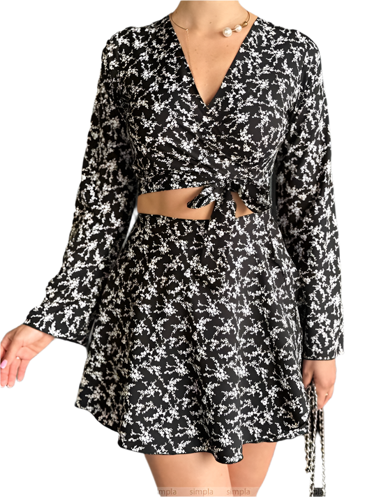 Black and white floral dress with long sleeves on a white background