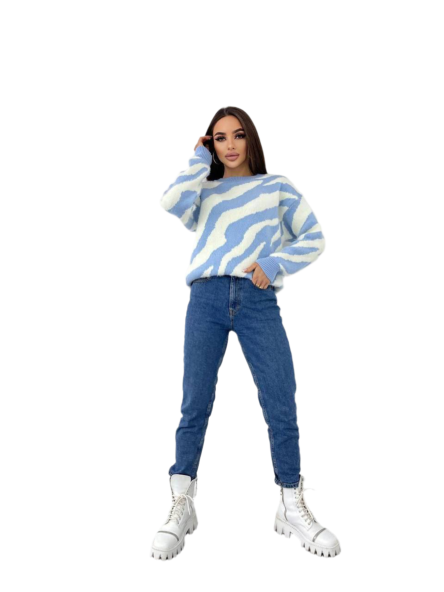 Person wearing a blue and white striped sweater with blue jeans on a white background
