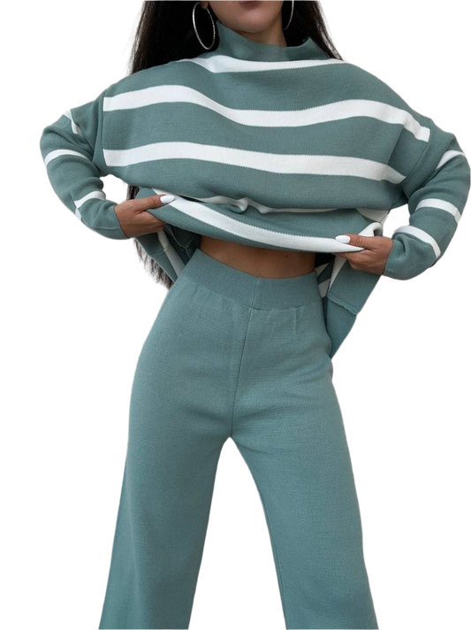 Person wearing a green and white striped sweater and matching pants on a white background