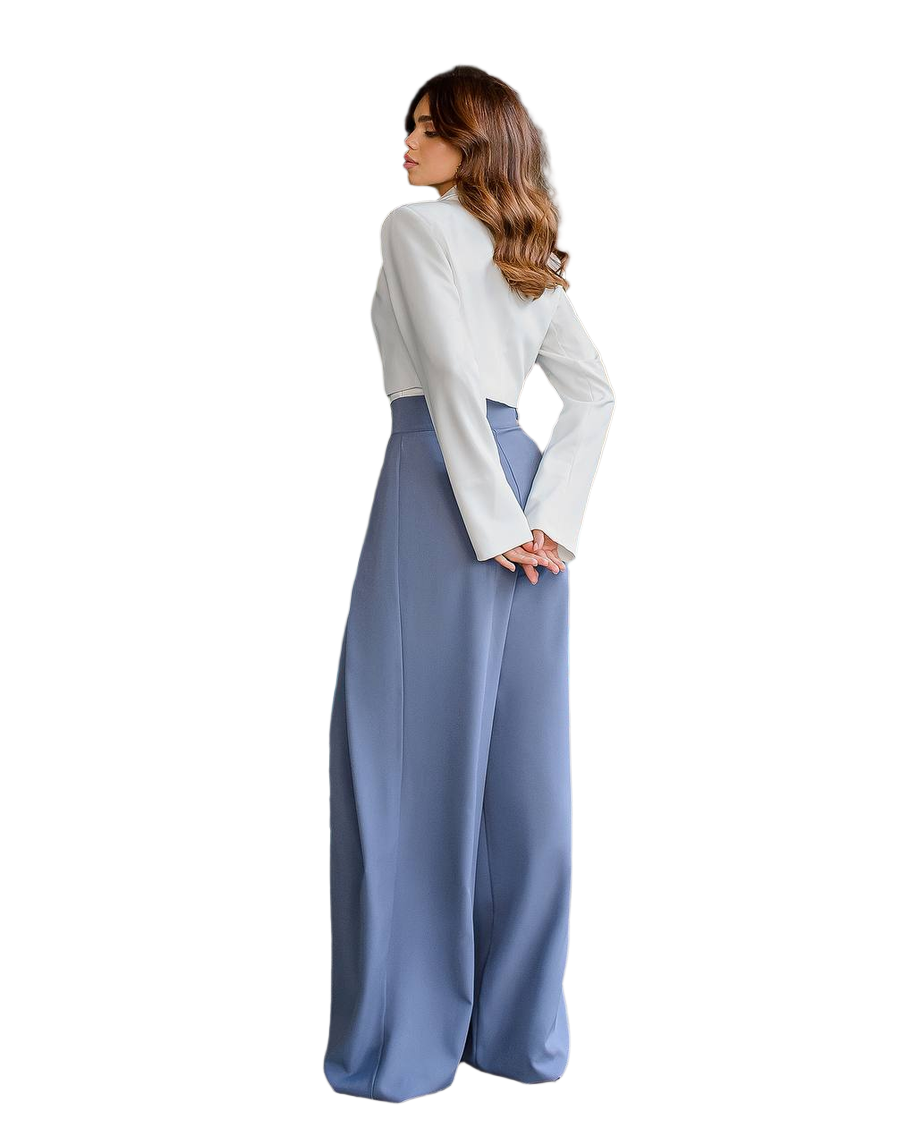 Woman wearing a white blouse and blue wide-leg pants on a white background