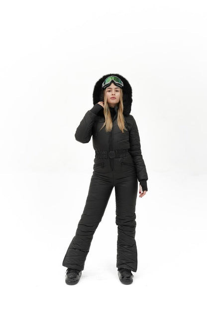 Person wearing a black snowsuit with a hood on a white background