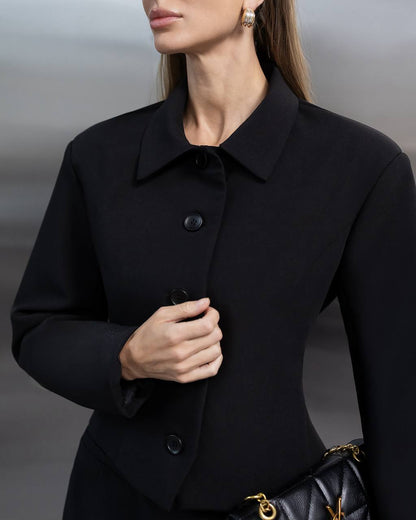 Woman wearing a black coat with a blurred background