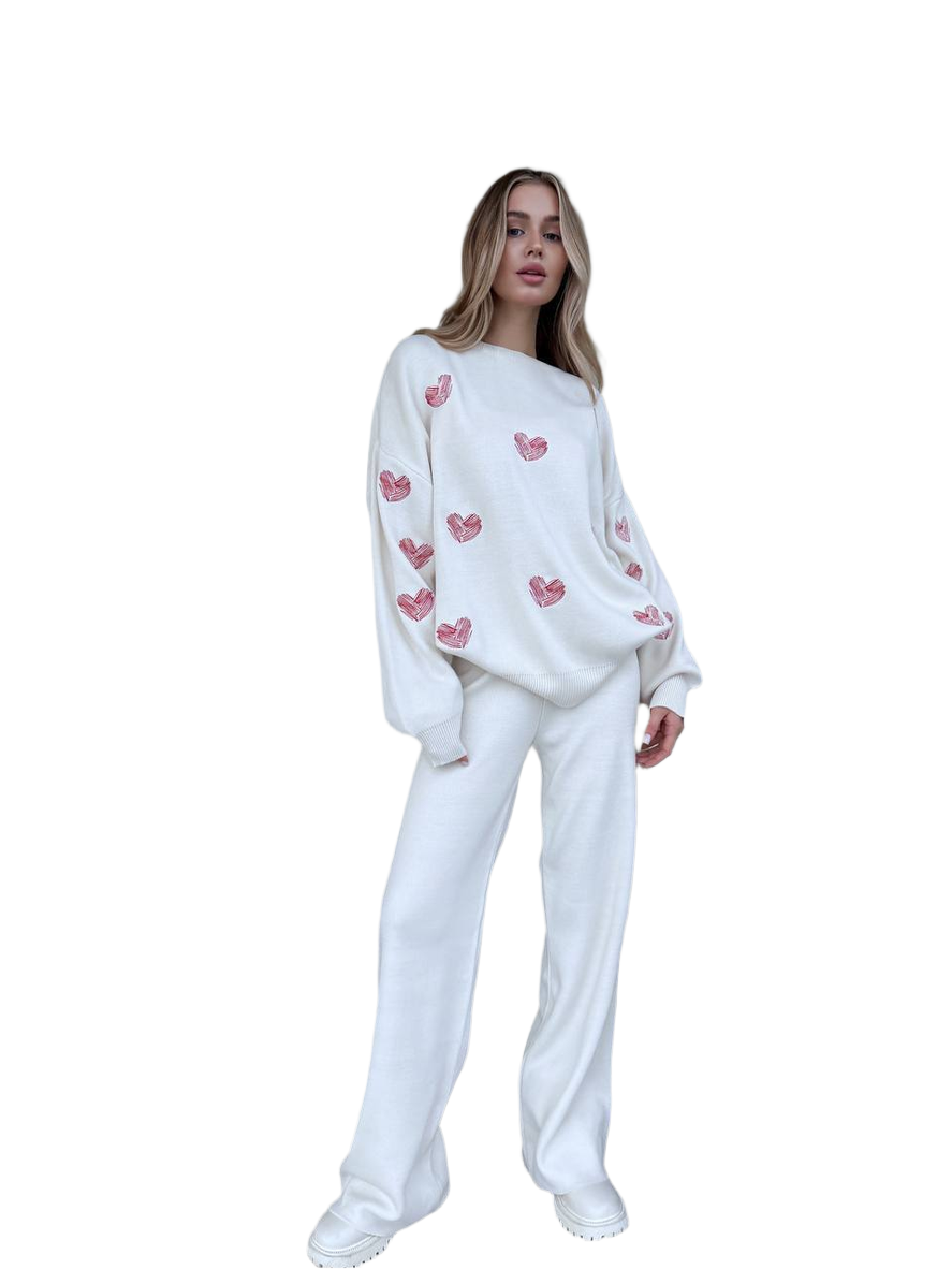 Woman wearing a white outfit with pink heart patterns on a white background