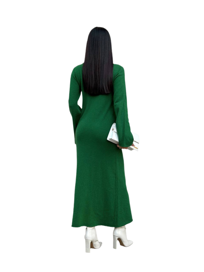 Person wearing a green dress with long sleeves on a white background