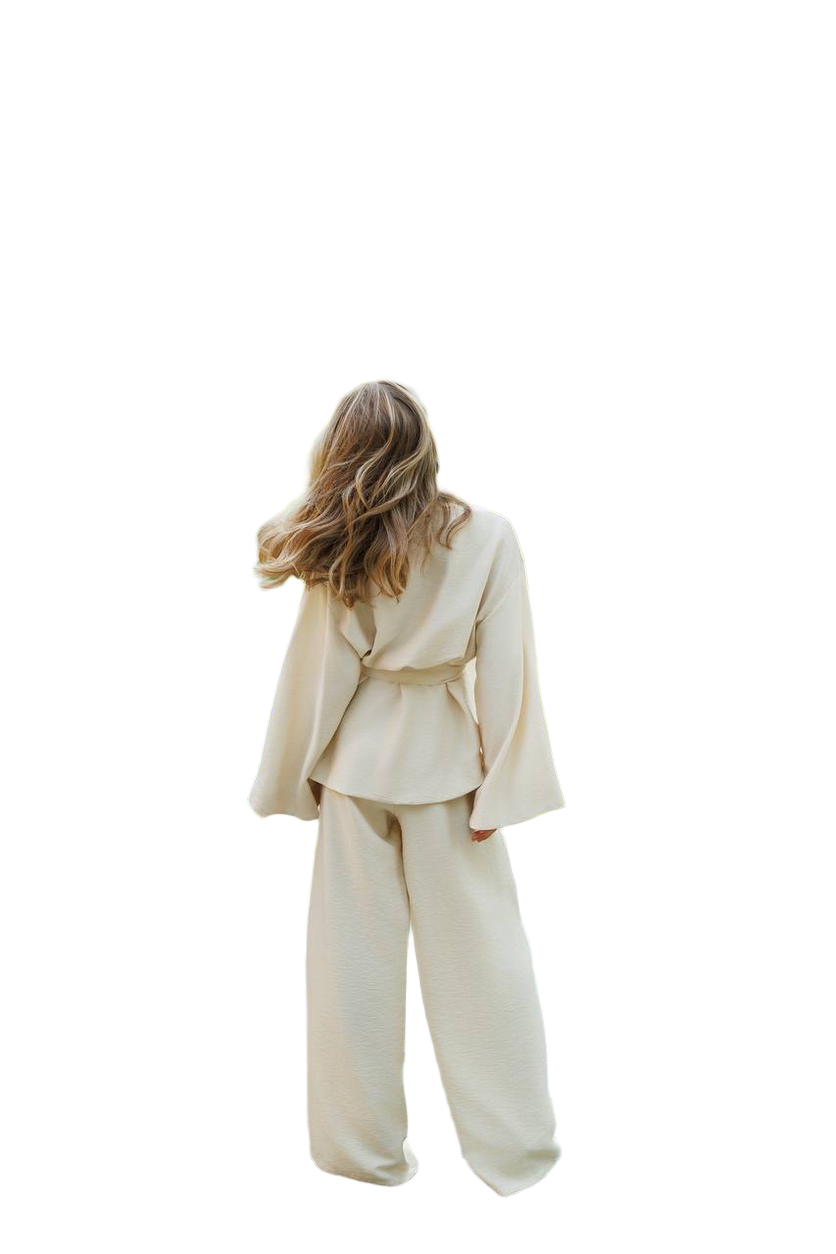 Person wearing a beige suit on a white background
