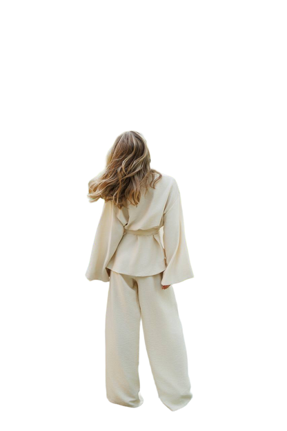 Person wearing a beige suit on a white background