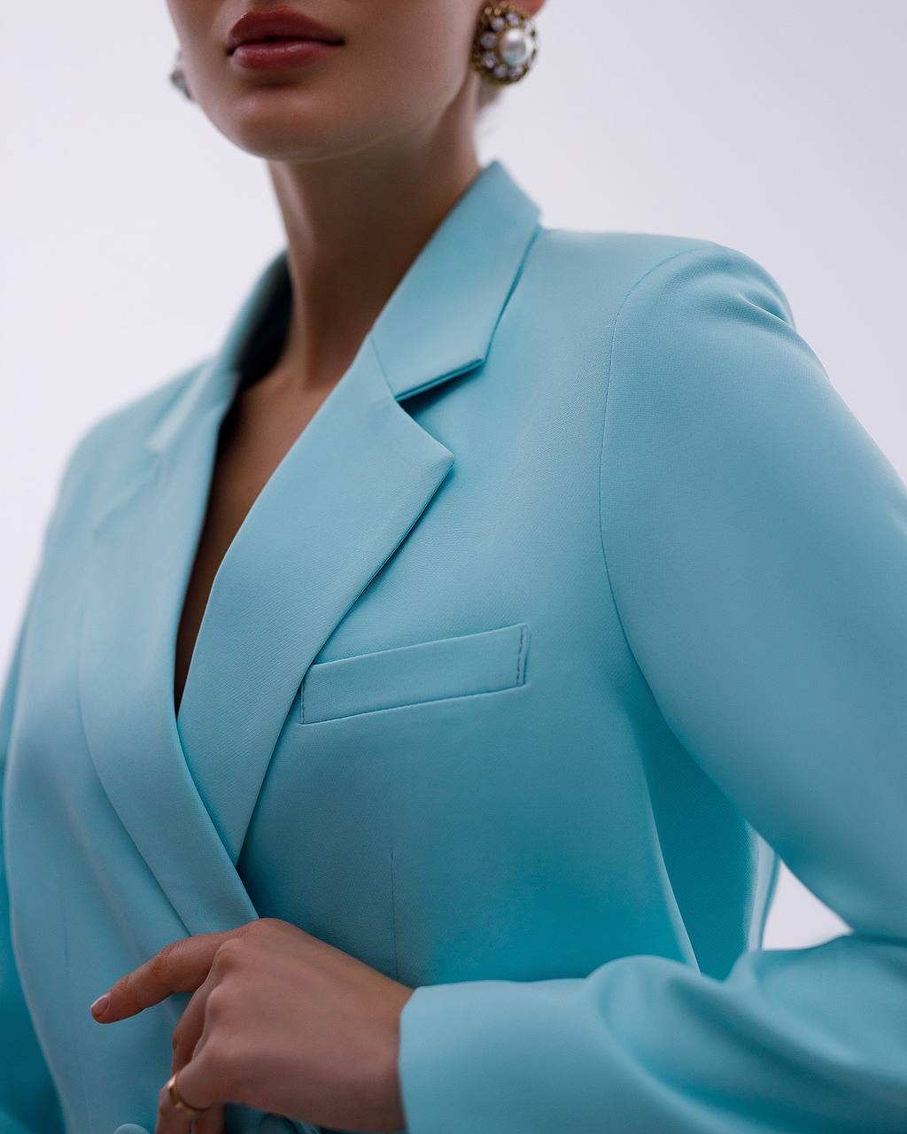 Light blue blazer worn by a person on a plain background