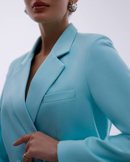 Light blue blazer worn by a person on a plain background