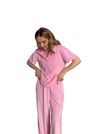 Woman wearing a pink pajama set on a white background