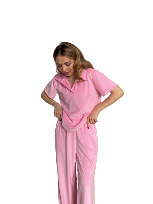 Woman wearing a pink pajama set on a white background