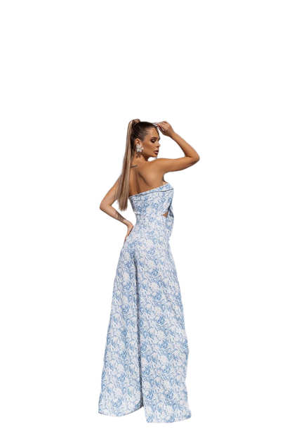 Woman wearing a blue floral strapless gown on a white background