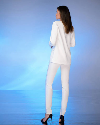 Woman wearing a white outfit against a blue gradient background