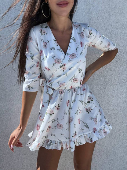 Woman wearing a floral dress against a gray background