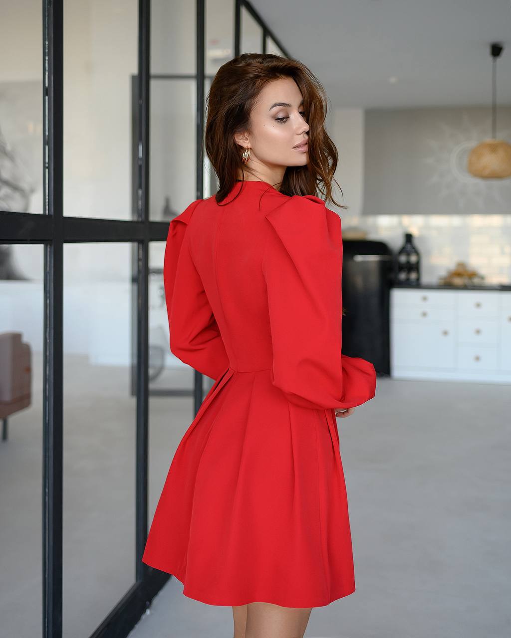 Woman wearing a red dress in a modern kitchen setting