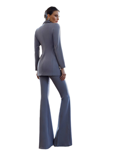 Woman wearing a gray suit with flared pants on a white background