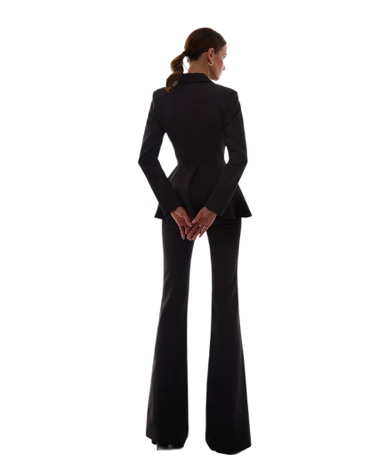 Person wearing a black suit on a white background