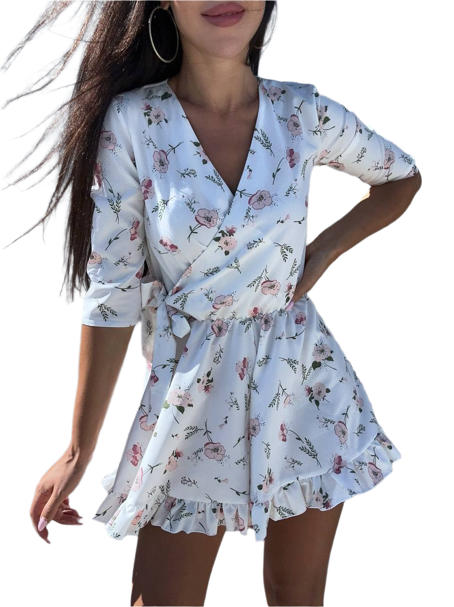 Woman wearing a floral wrap dress on a white background
