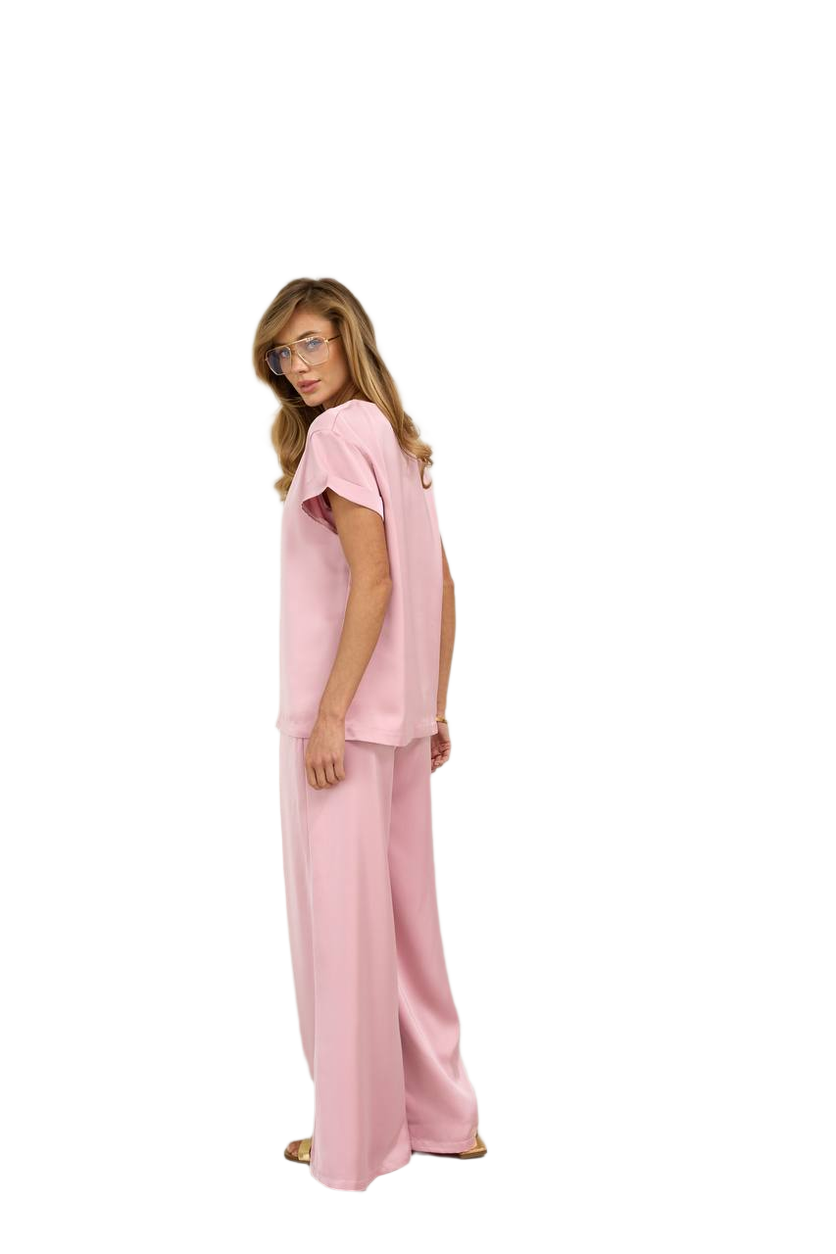 Woman wearing a pink outfit on a white background