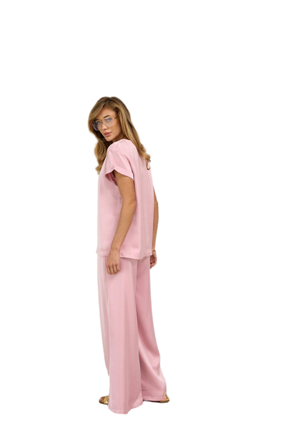 Woman wearing a pink outfit on a white background