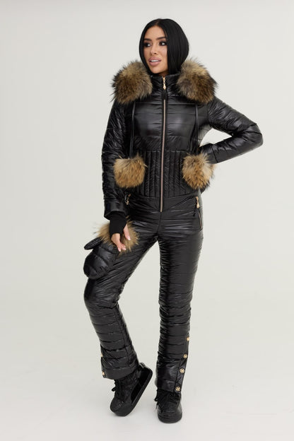 Person wearing a black snowsuit with fur trim on a white background