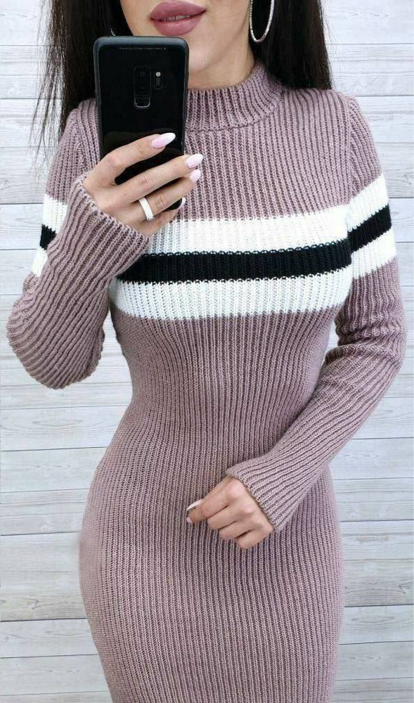 Person wearing a ribbed knit dress with horizontal stripes, holding a phone.