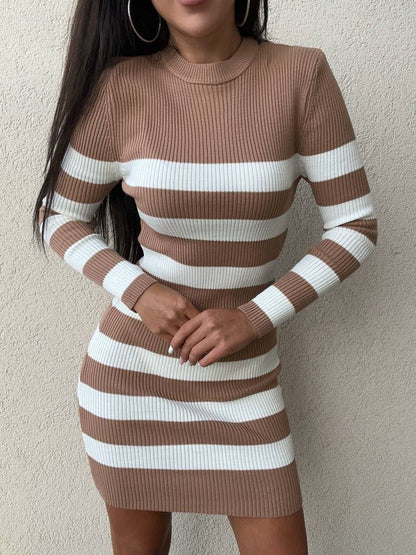 Brown and white striped dress worn by a person against a plain background