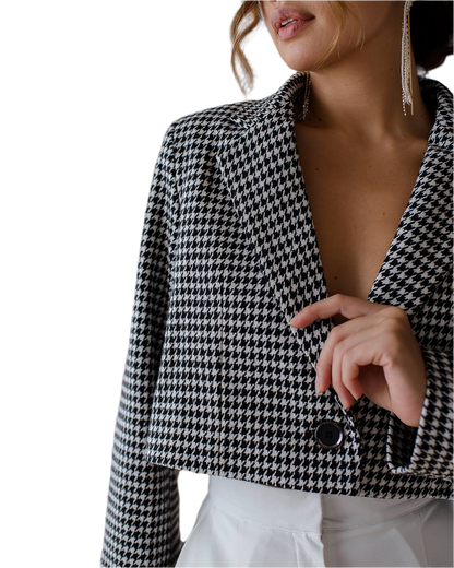 Houndstooth patterned blazer worn by a person on a white background