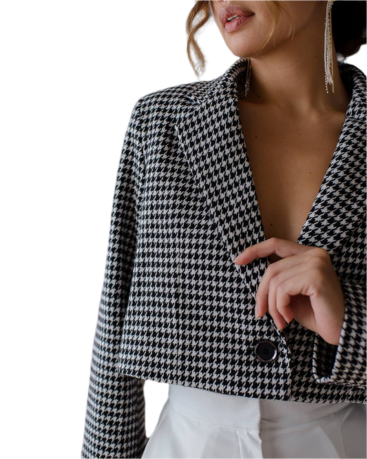 Houndstooth patterned blazer worn by a person on a white background