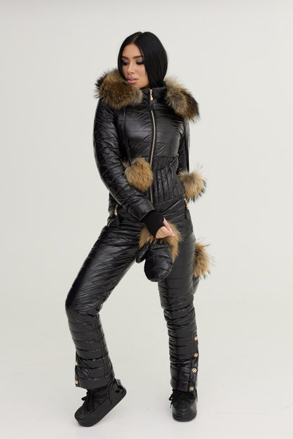 Person wearing a black snowsuit with fur trim on a white background