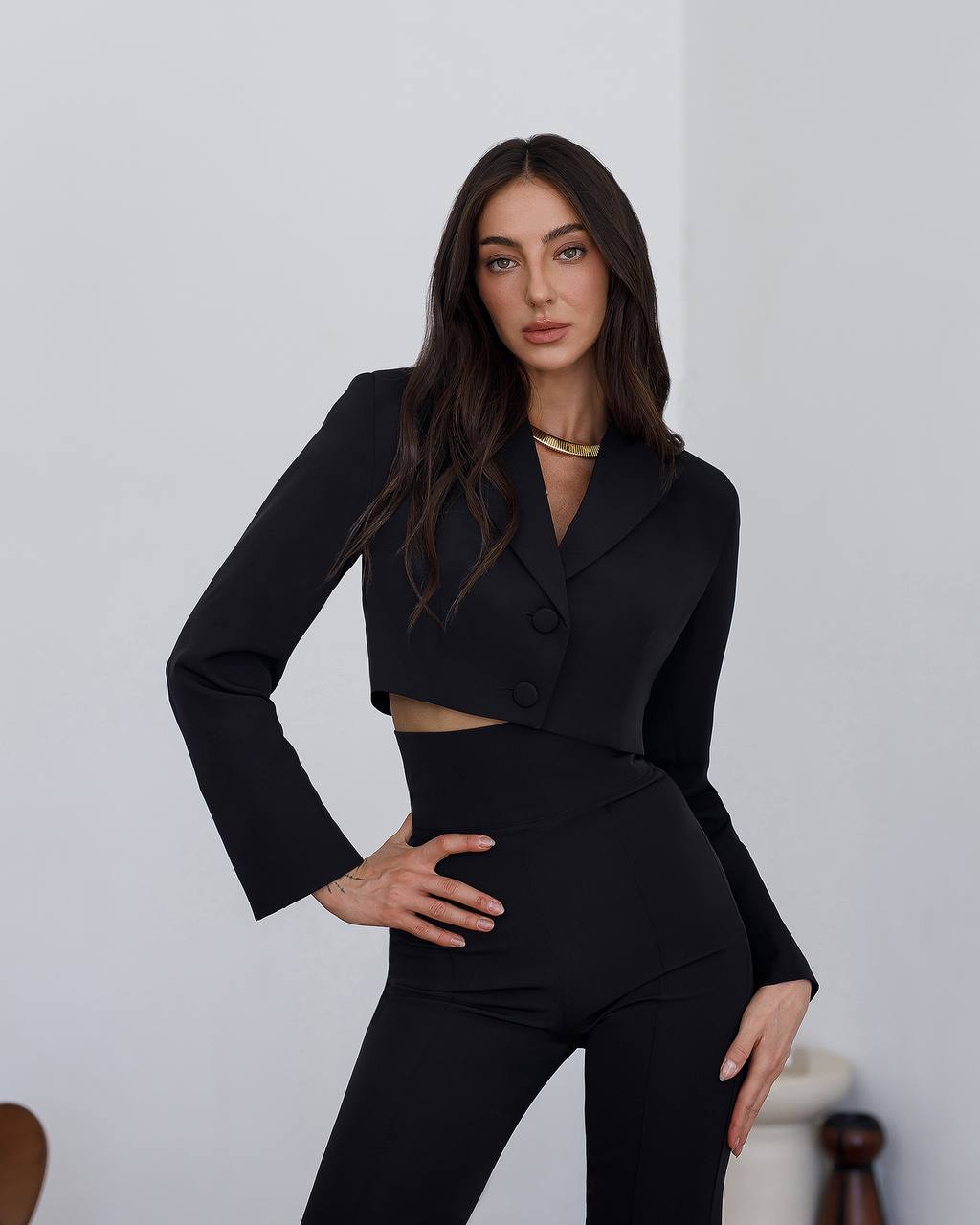 Woman wearing a black suit with a white background