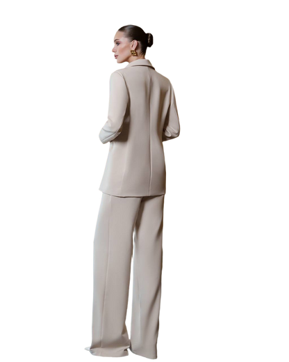 Woman wearing a beige suit on a white background