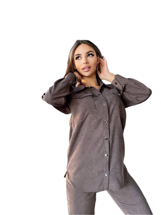 Woman wearing a brown button-up shirt and pants on a white background