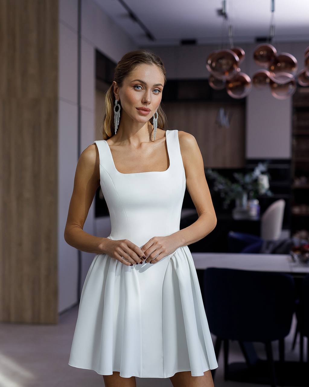 Woman wearing a white dress in an indoor setting