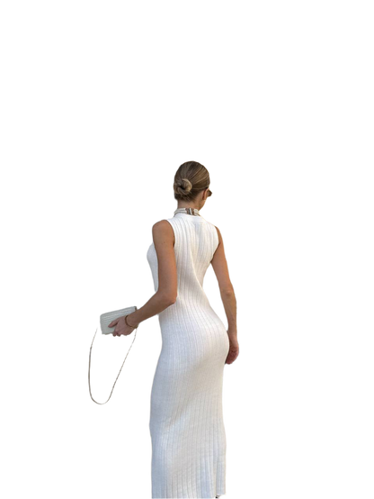 Woman wearing a white sleeveless dress with a high slit on a white background