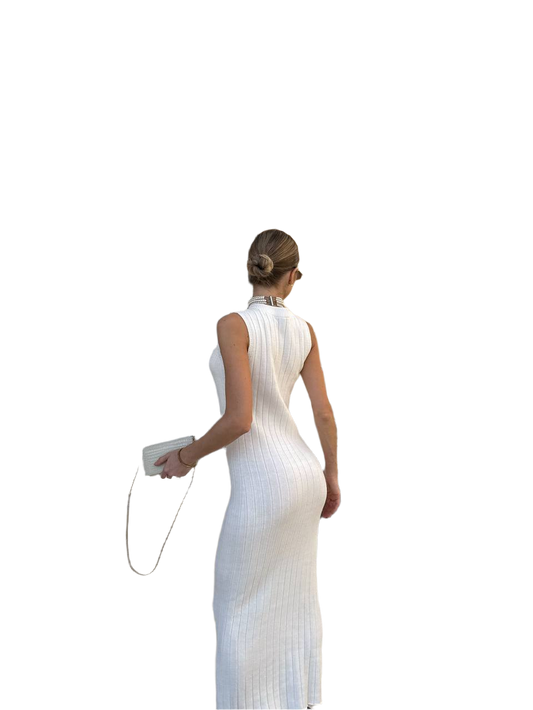 Woman wearing a white sleeveless dress with a high slit on a white background