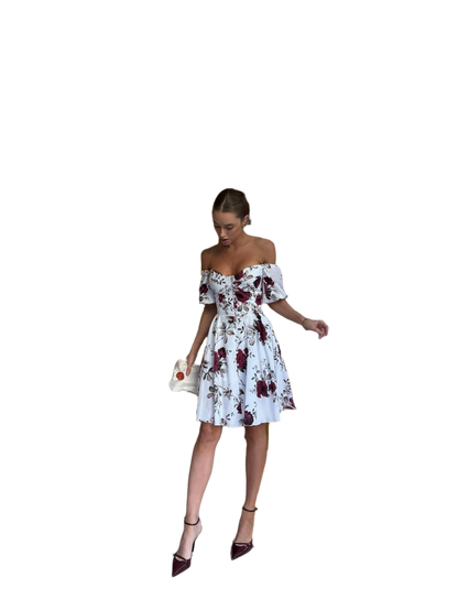 Woman wearing a floral off-shoulder dress on a white background