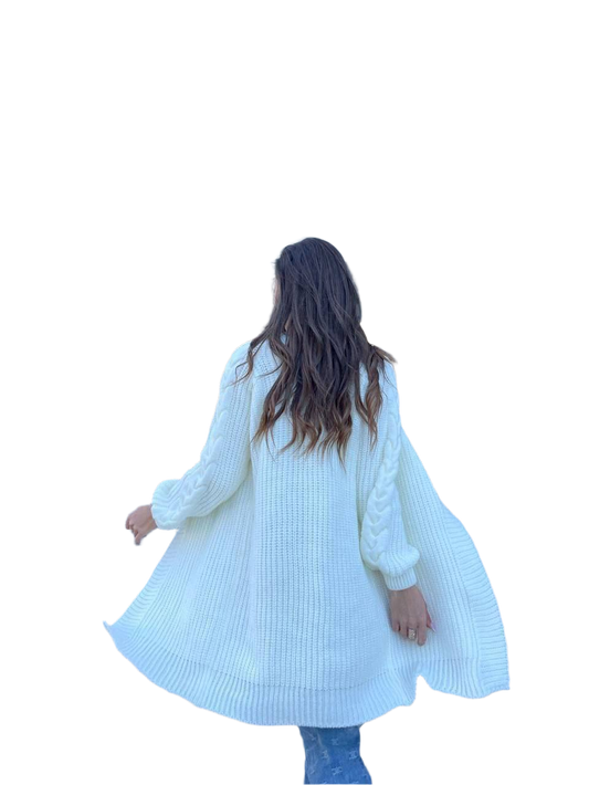 Person wearing a long white cardigan on a white background