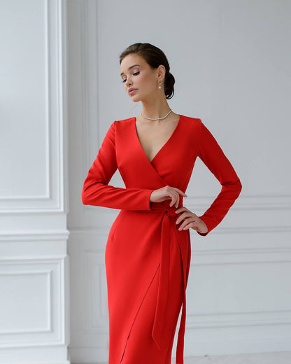 Woman wearing a red dress against a white wall