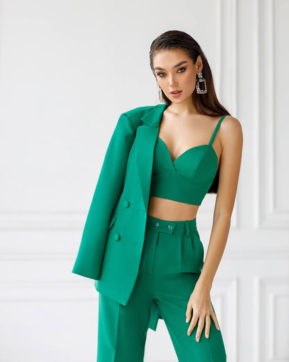 Woman wearing a green suit with a white background