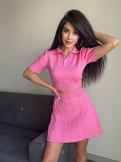 Woman wearing a pink outfit posing against a neutral background