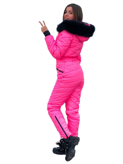 Person wearing a bright pink puffer suit with a black fur-lined hood on a white background