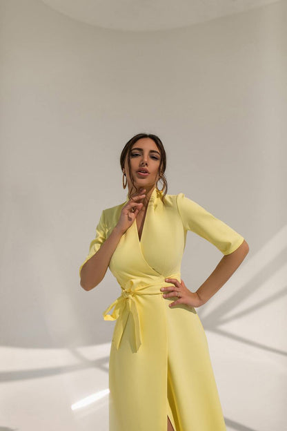 Woman wearing a yellow dress against a plain background